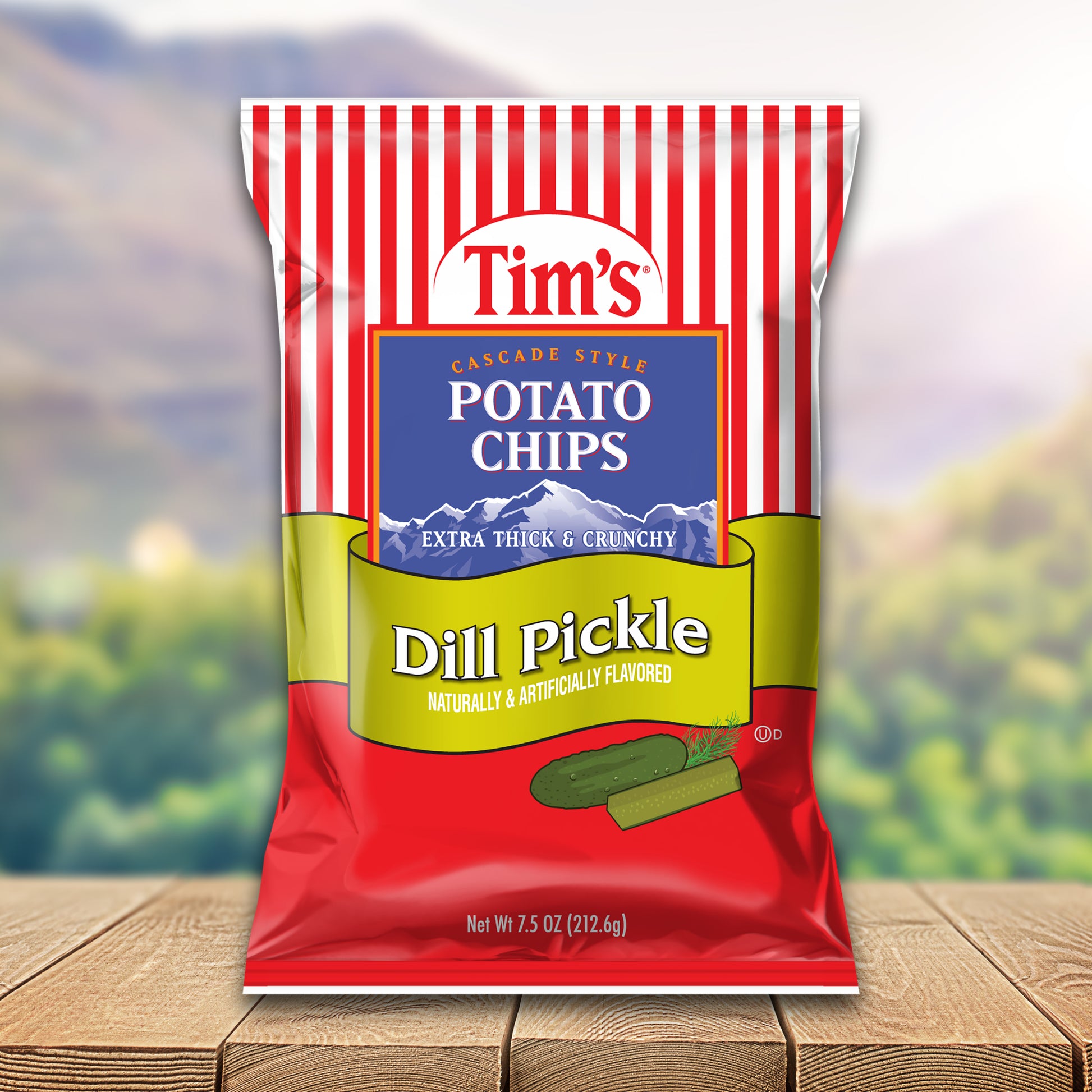 Bag of Tim's Dill Pickle potato chips on a wooden surface with a blurred natural background