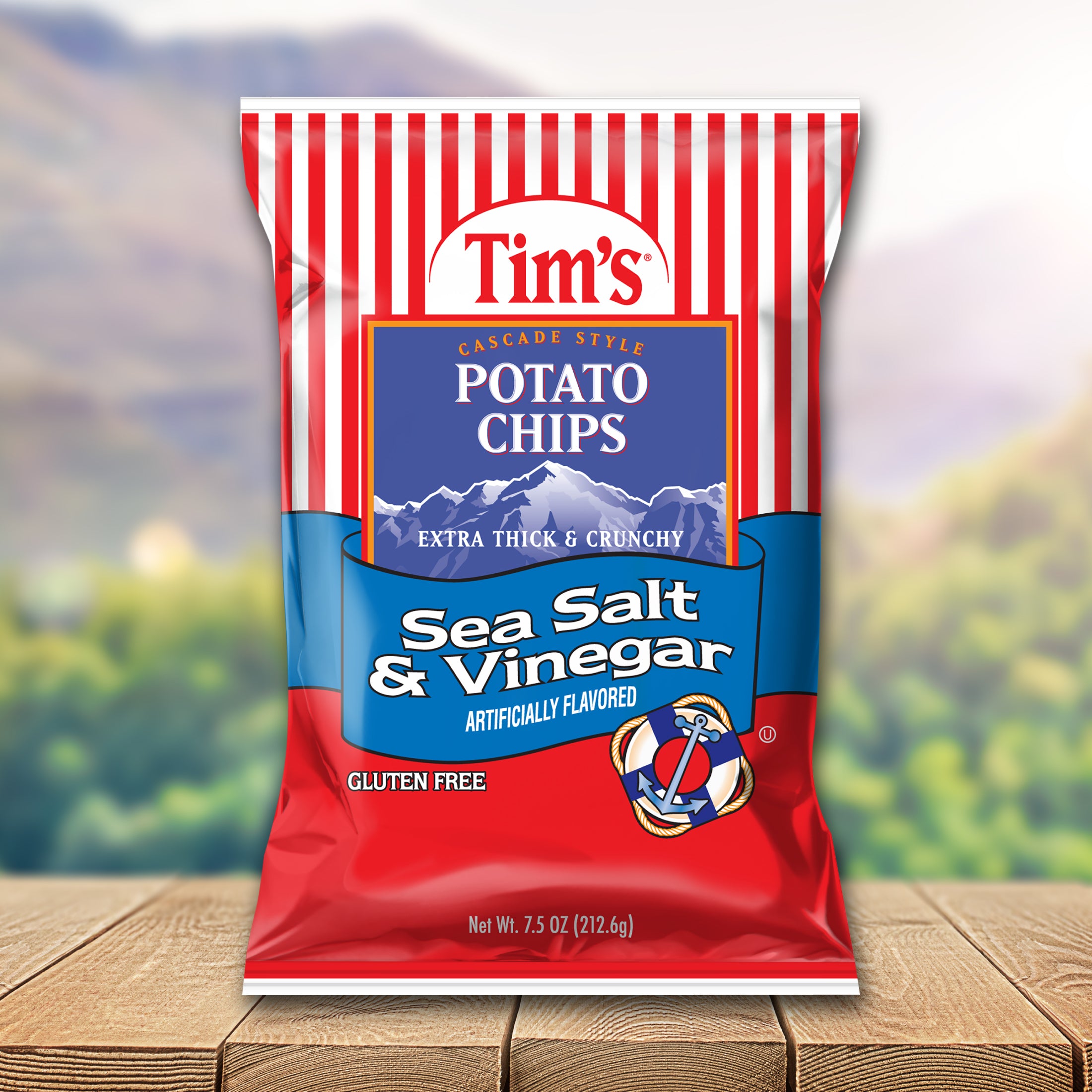 Tim's Sea Salt & Vinegar potato chips packaging on a wooden surface with a blurred natural background