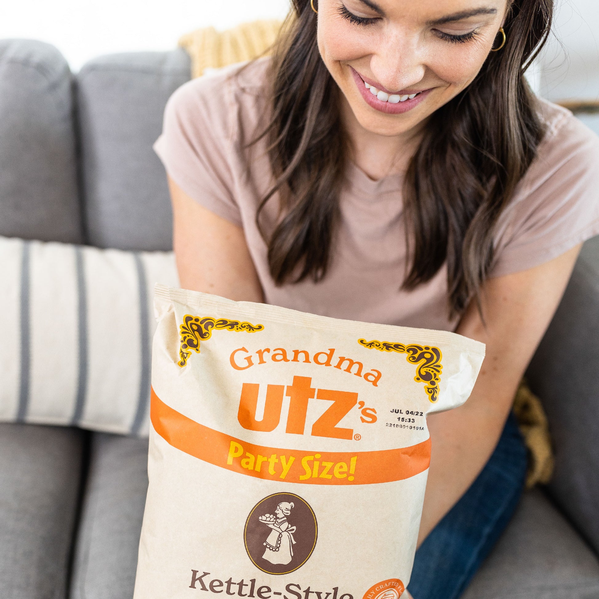 Woman holding Grandma Utz’s Party Size Kettle-Style Potato Chips