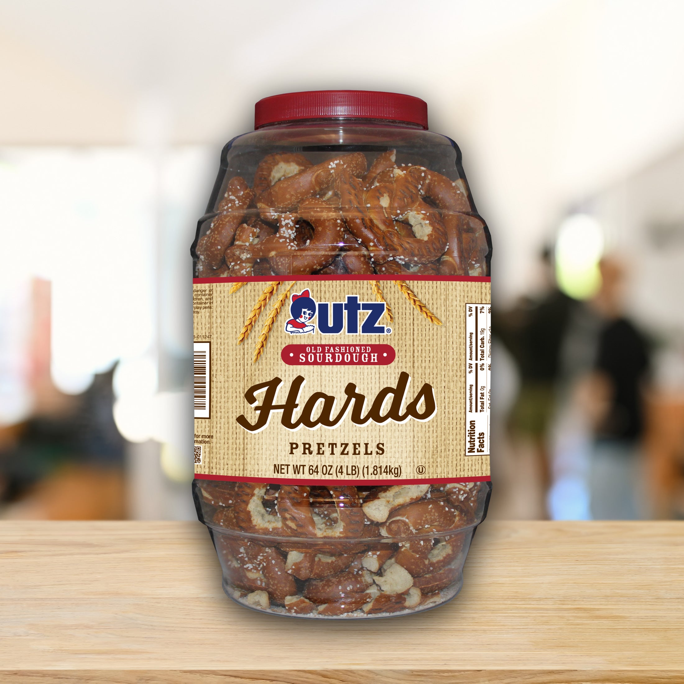 Jar of Utz Hards Pretzels on a wooden surface with a blurred background