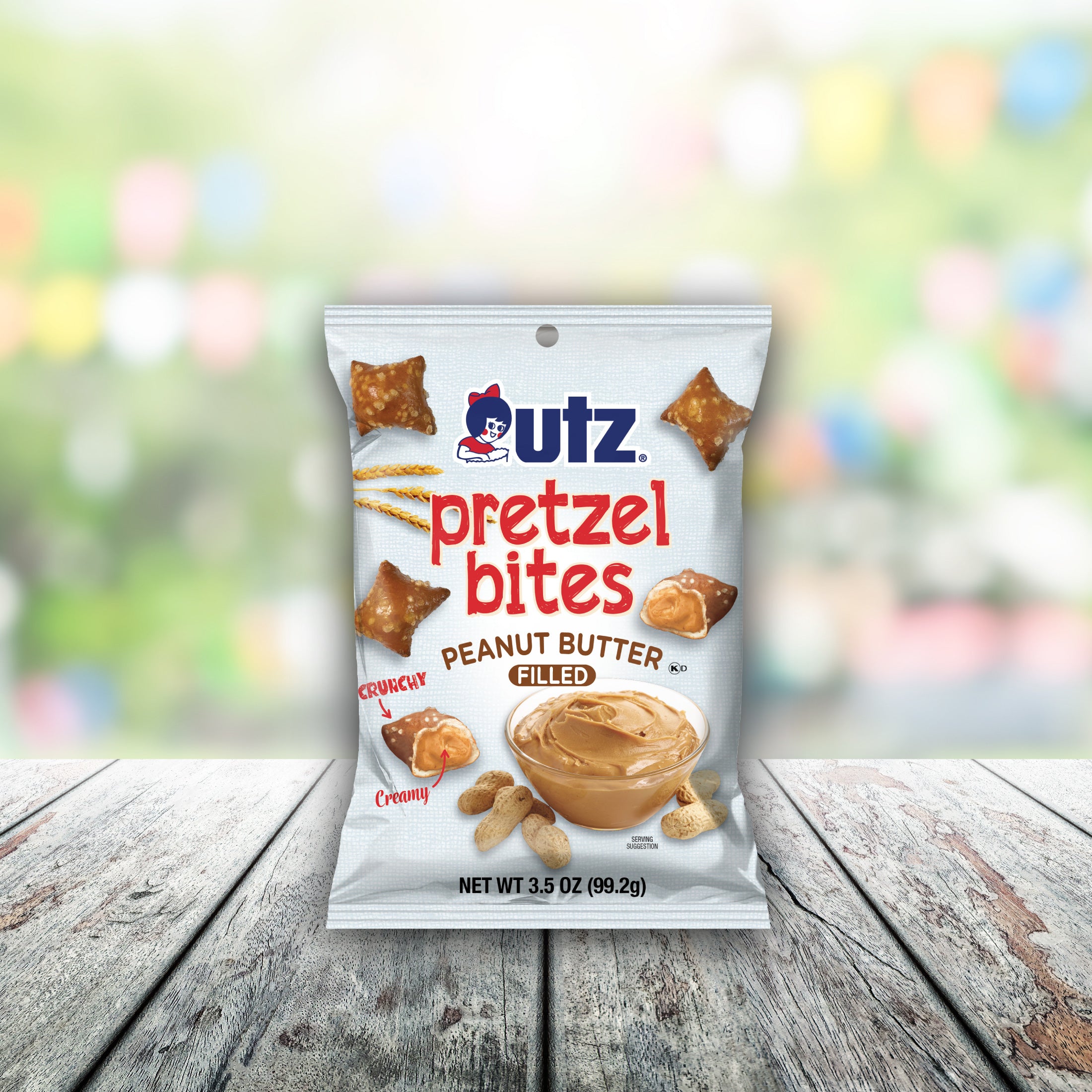 Packaging of Utz Pretzel Bites Peanut Butter Filled on a wooden surface with a blurred colorful background