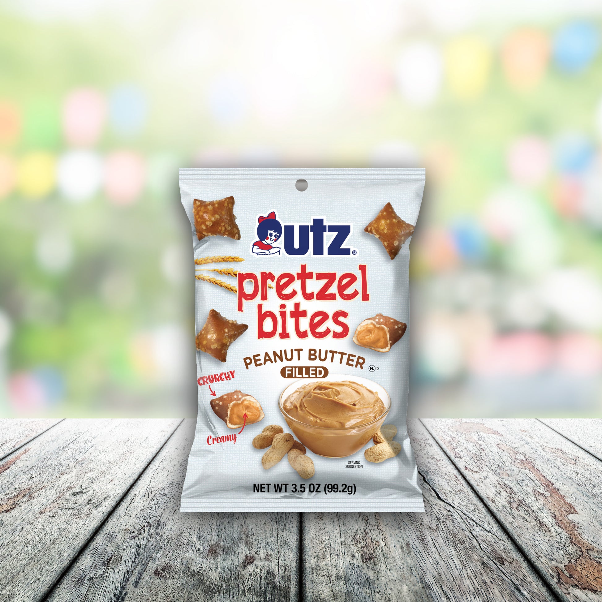 Packaging of Utz Pretzel Bites Peanut Butter Filled on a wooden surface with a blurred colorful background