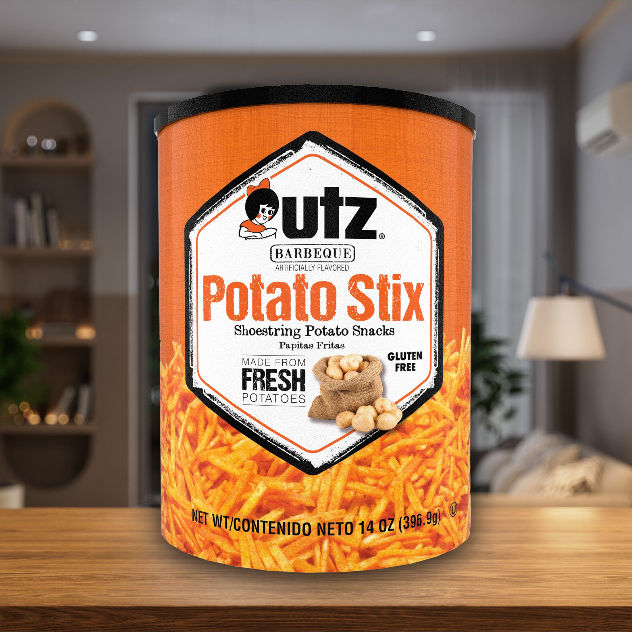 Can of Utz Barbeque Potato Stix on a wooden table with a blurred indoor background