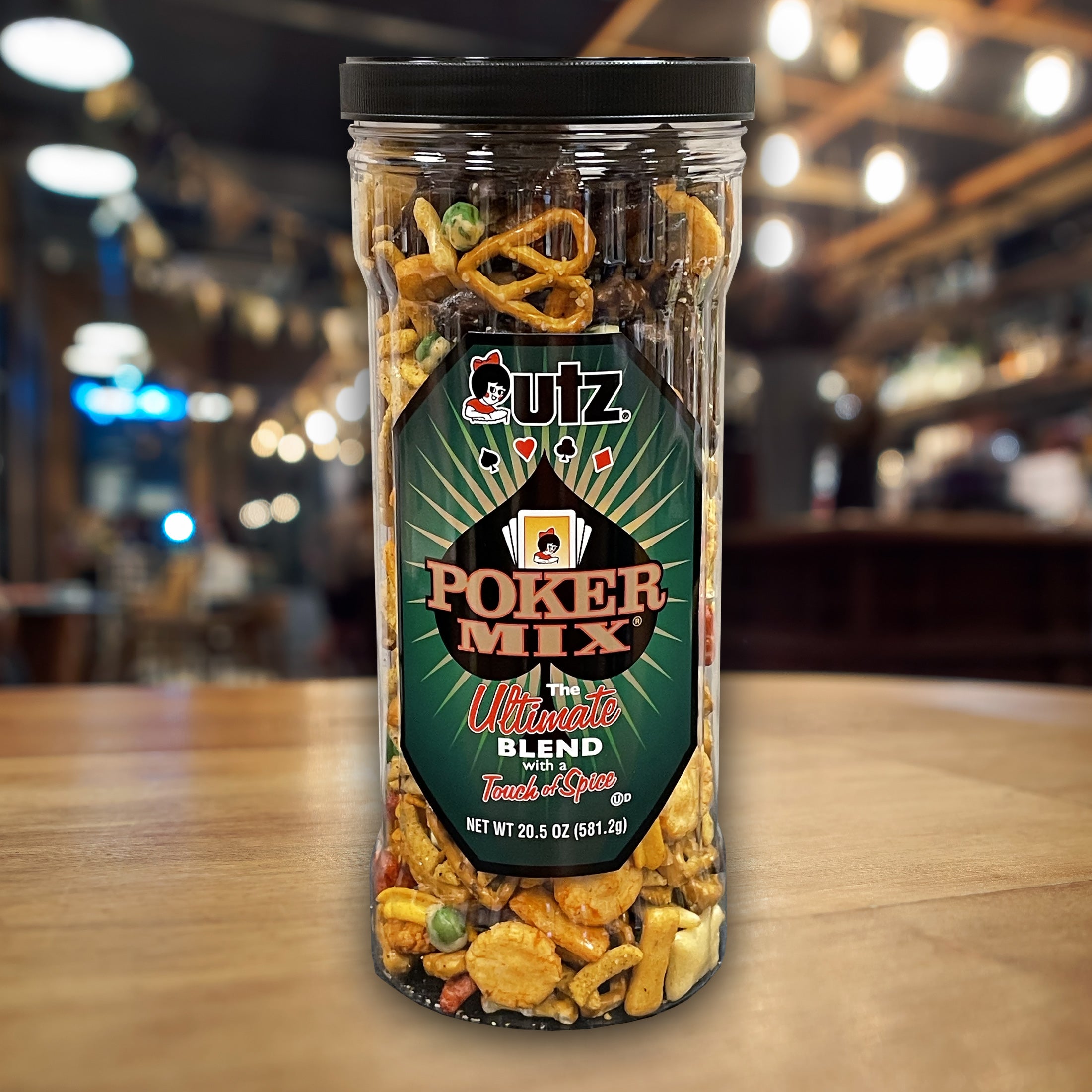 Jar of utz Poker Mix on a wooden table with a blurred background