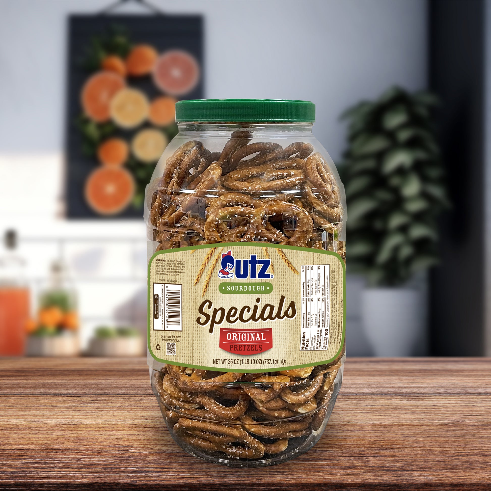 Jar of Utz Specials pretzels on a wooden surface with a blurred background