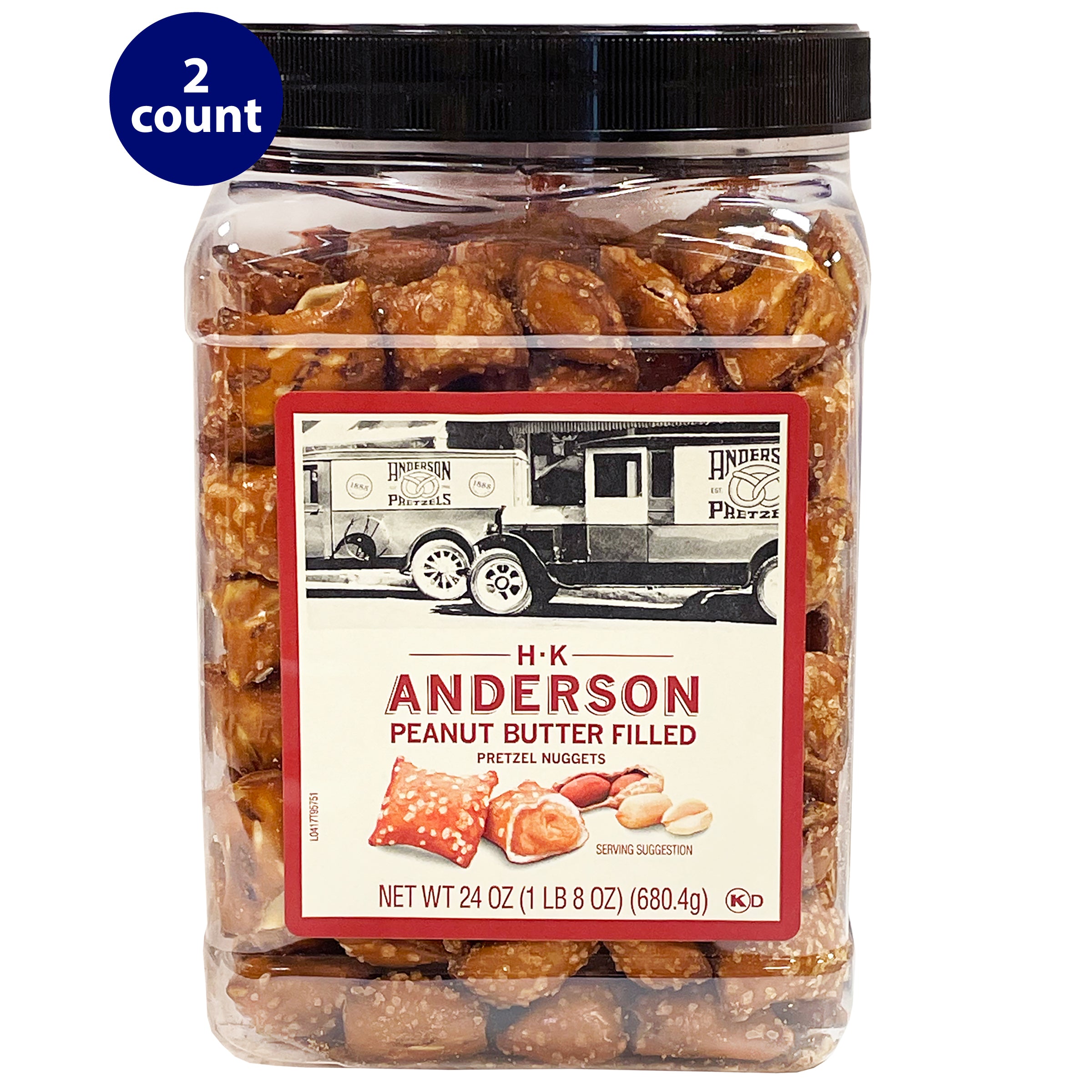 A large container of H.K. Anderson Peanut Butter Filled Pretzel Nuggets with a black lid. The label features a vintage black-and-white image of an Anderson Pretzel delivery truck and the product name in bold red letters. The container holds 24 oz (1 lb 8 oz) or 680.4g of pretzel nuggets filled with peanut butter. A "2 count" label is visible in the top left corner.