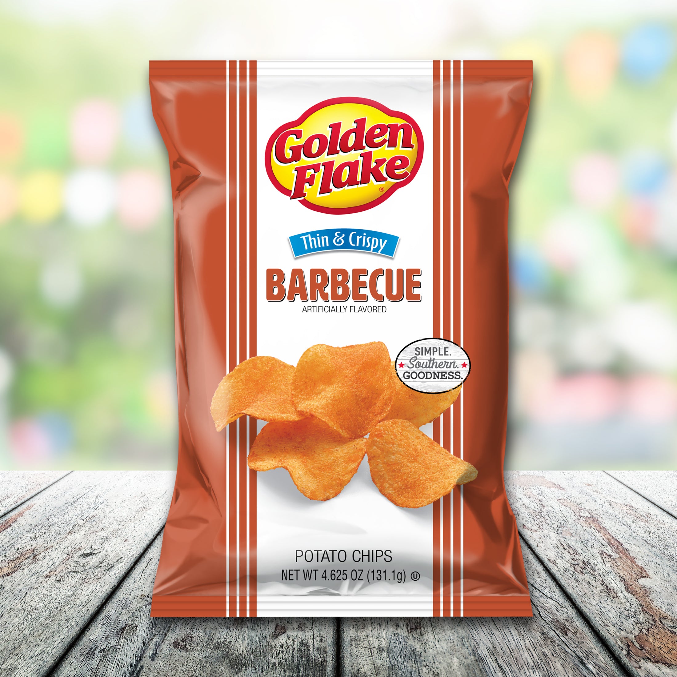 Packaging of Golden Flake Barbecue potato chips on a wooden surface with a blurred background