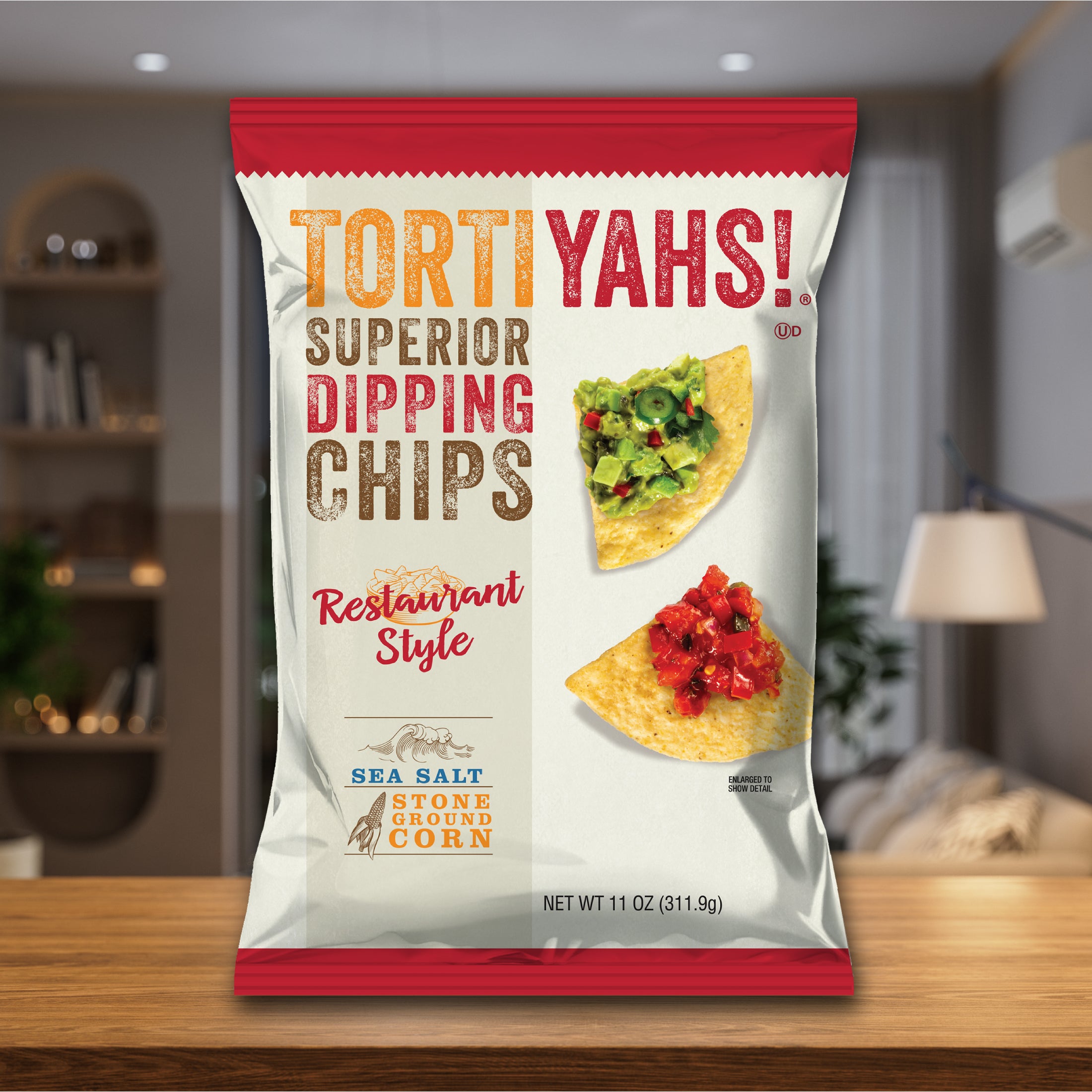 Tortiyahs! dipping chips packaging on a wooden surface with a blurred indoor background