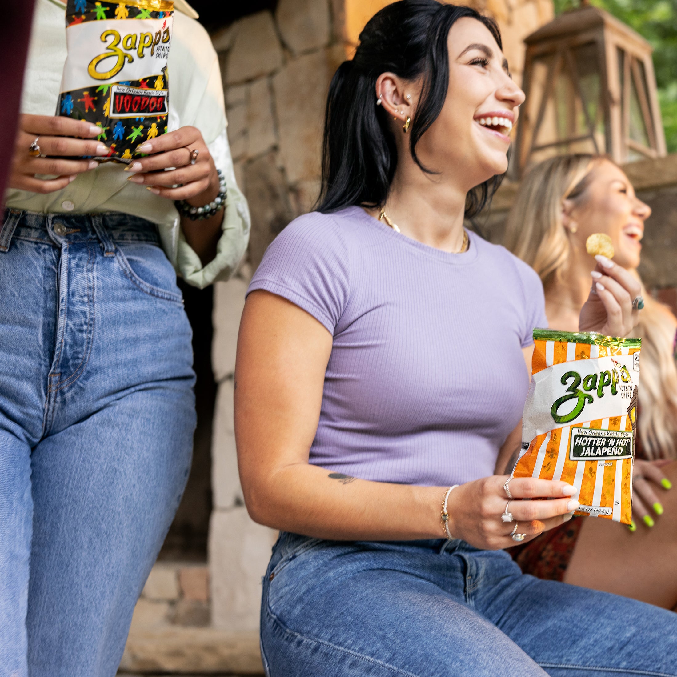 Women enjoying Zapp’s potato chips outdoors