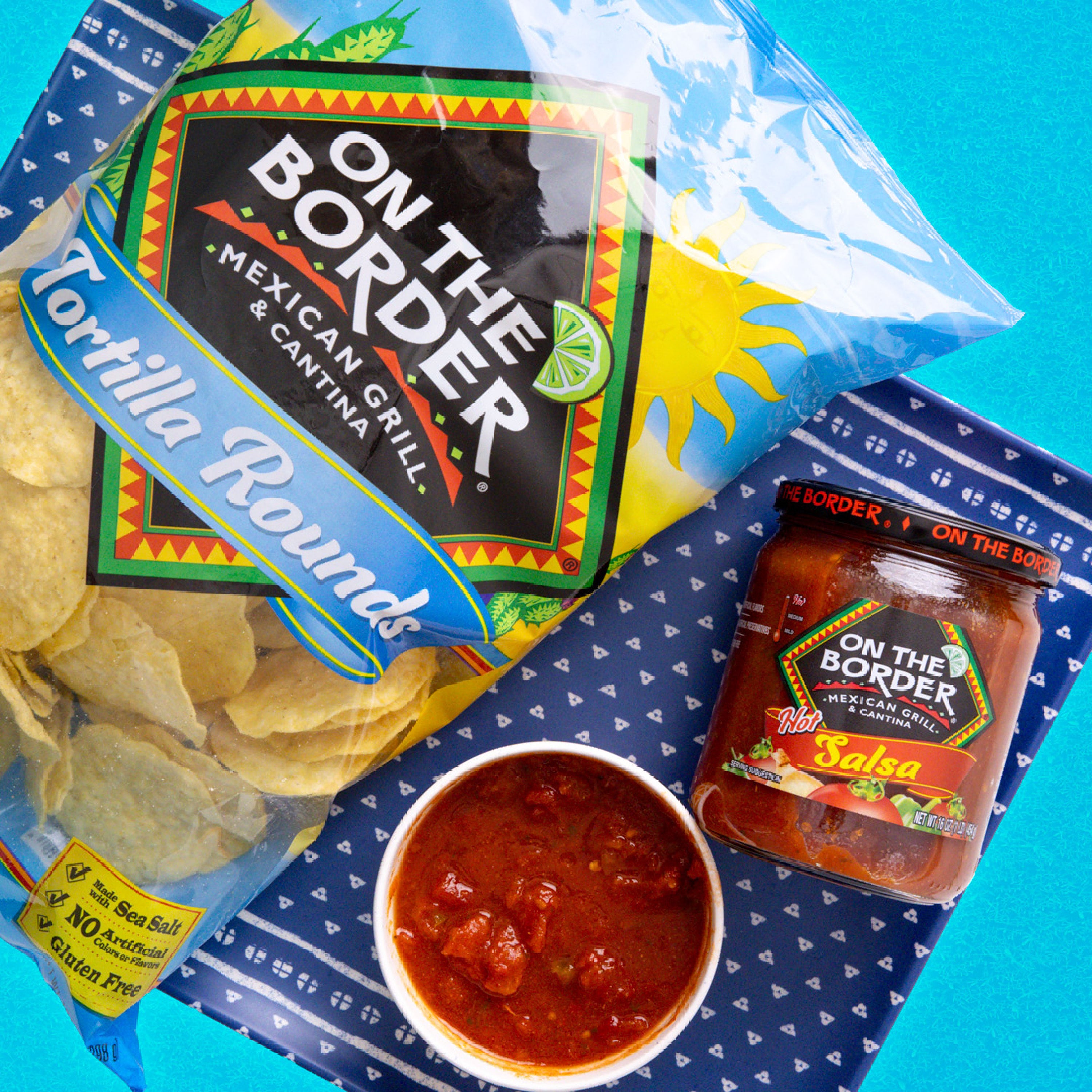 On The Border tortilla rounds, salsa, and a bowl of salsa on a blue patterned background