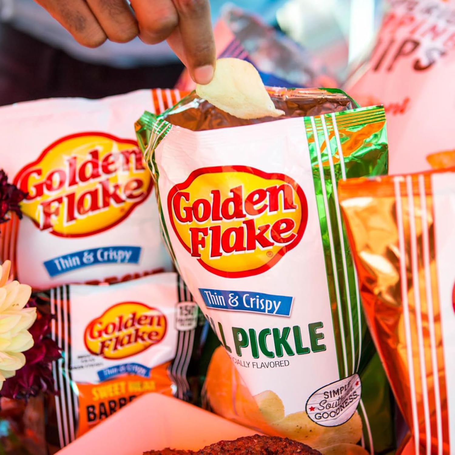 Packaged snacks with Golden Flake branding, including a pickle-flavored snack.