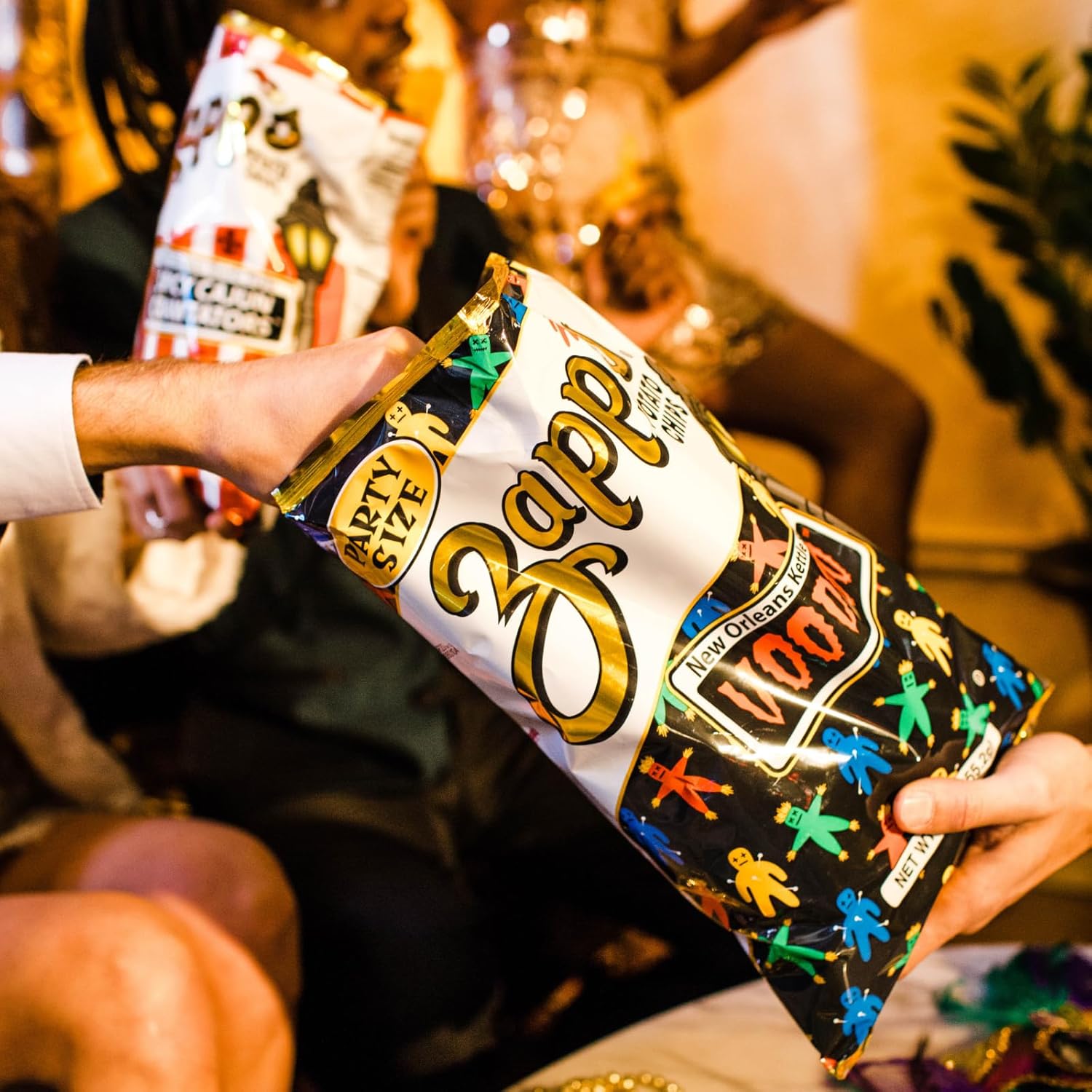 Person holding a Zapp New Orleans Style Hot Sauce packet with colorful design