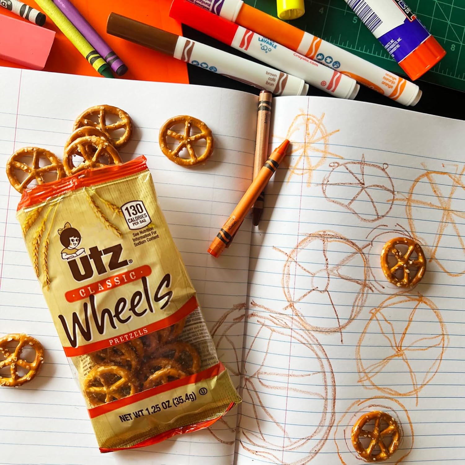 Packaged Utz Classic Wheels pretzels on a notebook with drawings of pretzels.