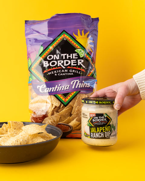 On The Border jalapeno ranch dip and cantina thins on a yellow background