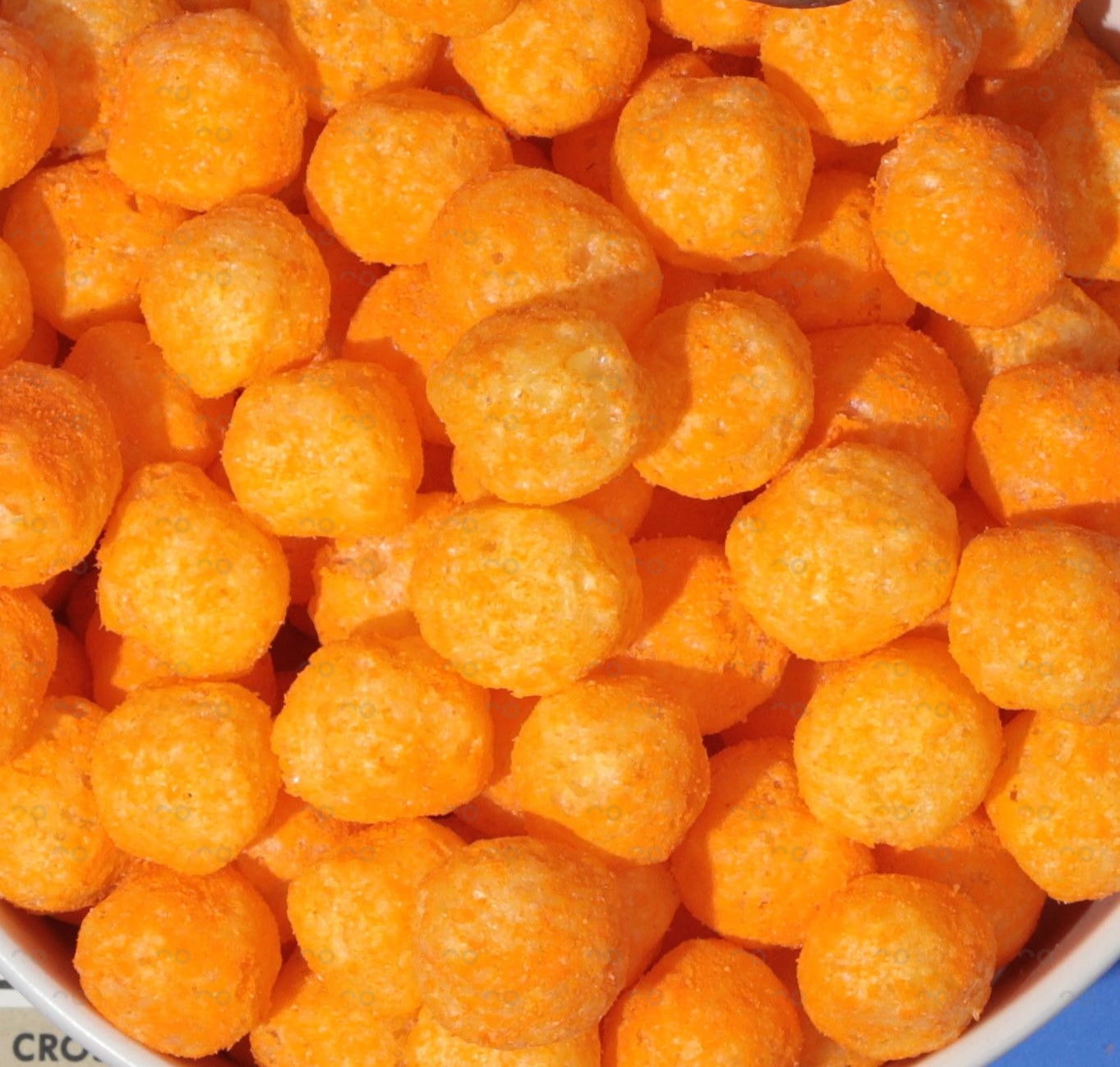 Close-up of orange candy balls in a bowl